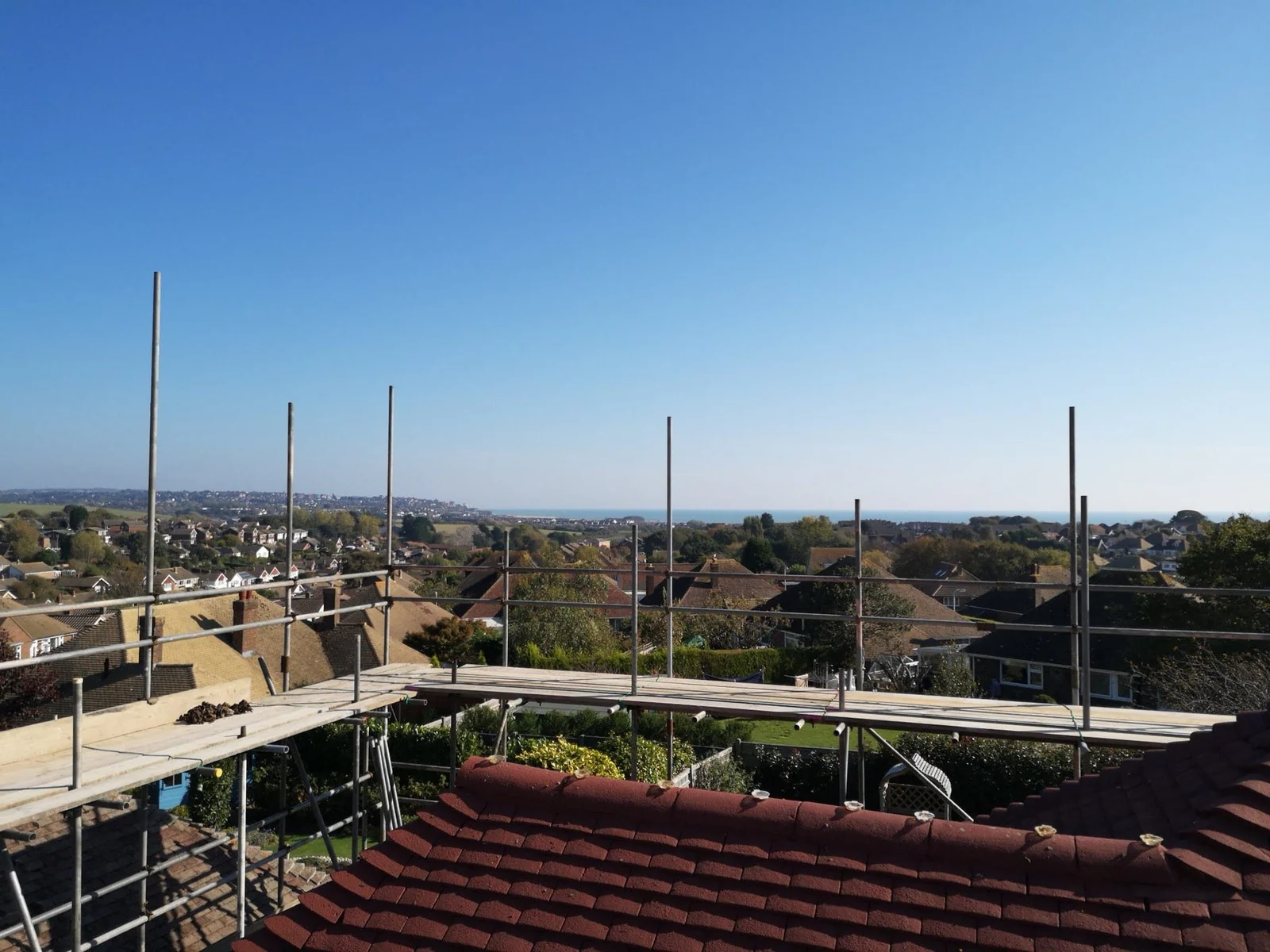 View from a scaffold platform over Hastings rooftops to the sea