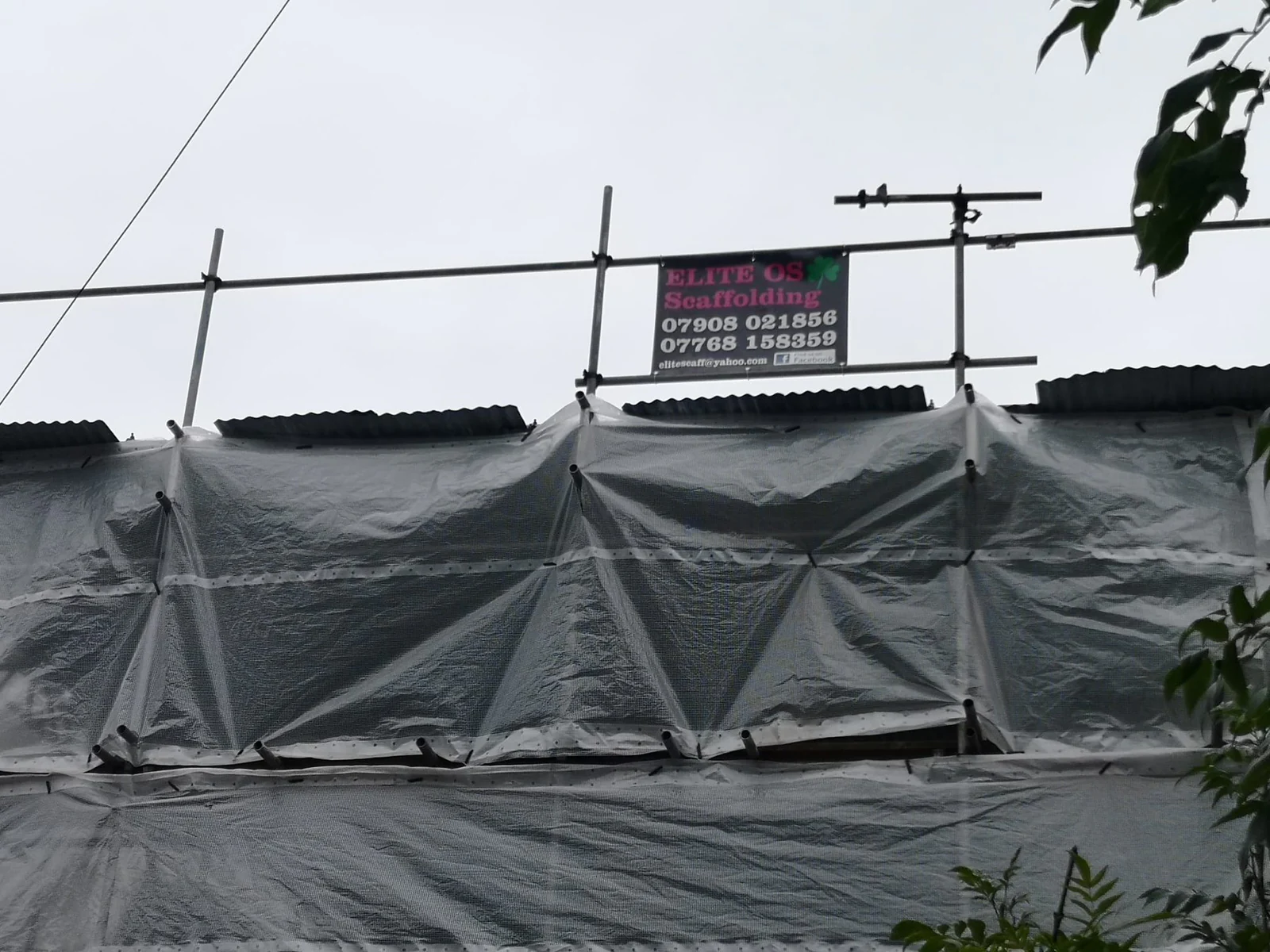 Temporary roof sheeting with an Elite Scaffolding site board